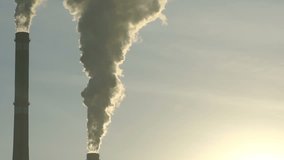 Footage industrial chimneys emits toxic pollutants into the sky polluting the environment. hd vdeo