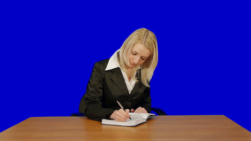 young businesswoman writing in notebook