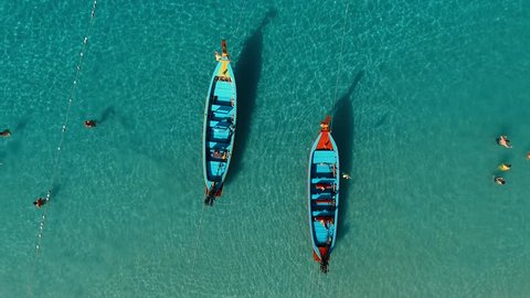 Aerial: Two long tail boats on the beach.