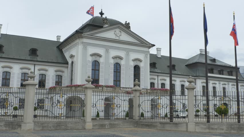 Slovakian and European Union flags waving in the wind in fron of the Grassalkovich Palace in Bratislava.