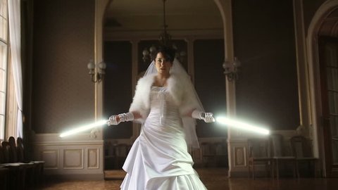 Funny pretty bride playing jedi with lightsaber