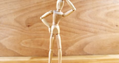 Conceptual image of figurine standing with hand on head