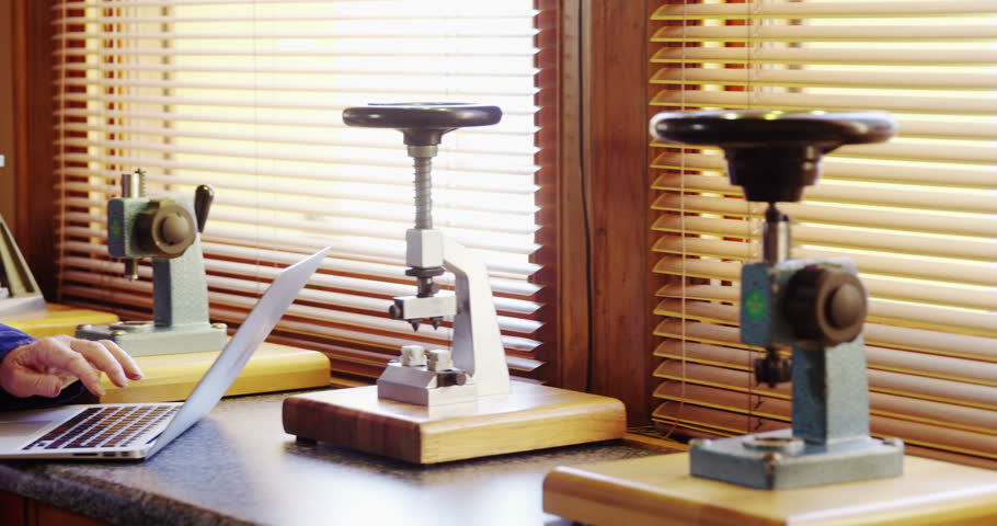 Horologist using laptop in the workshop