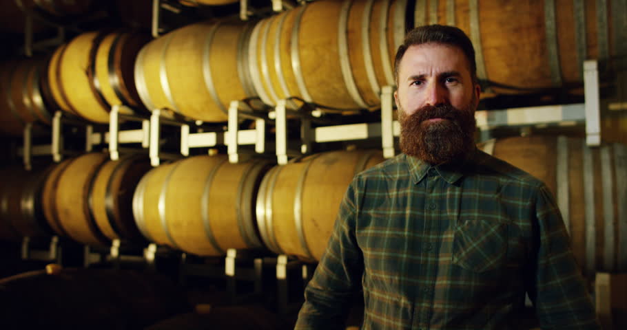 A brewmaster expert checks the quality of the freshly tapped beer from wooden barrels formerly used for flavour the wine or beer.
passion for beer and wine.
old and traditional jobs. | Shutterstock HD Video #21399307