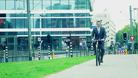 Business male cycling to office Stock Video