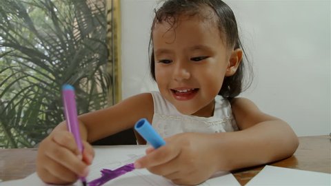 Girl Coloring Drawings Sequence (HD). Three shot sequence of a four year old Hispanic girl doing some coloring with felt pens on some drawings, in this case some ice cold pops.  Stock Video