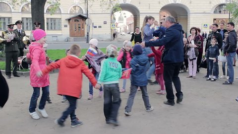 Happy Children Round Dancing Under The Sounds Of A Military March from the repertoire of army Orchestra. Musical performance Concert For Passers of all ages, Saint Petersburg, Russia, may 2016