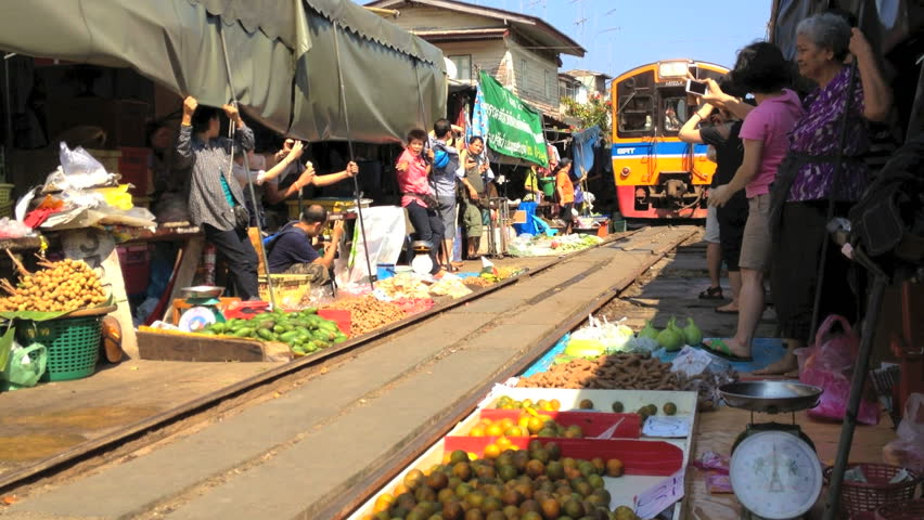 MAEKLONG - FEBRUARY 25: A train is going through the Maeklong Market on February