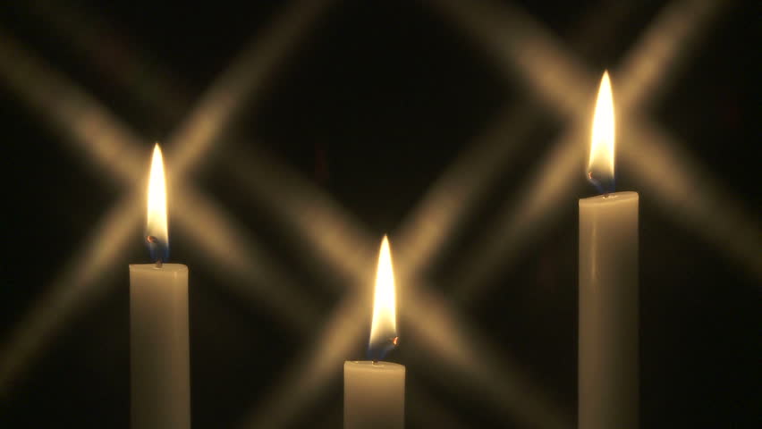 Three candles burning in the dark