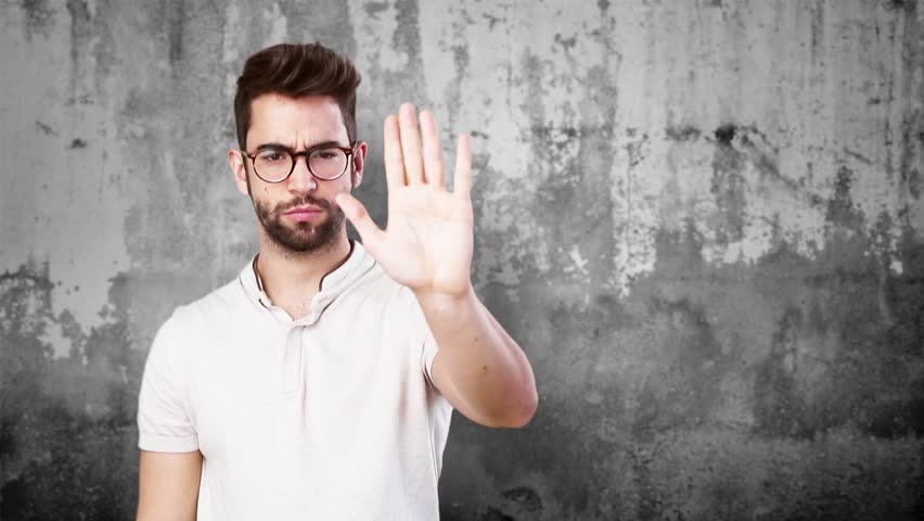 young man doing stop gesture on a wall Royalty-Free Stock Footage #21425650