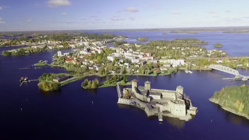 Approaching aerial shot of the town of Savonlinna in Finland in middle of lakes. Slow motion shot, in early autumn 2016.