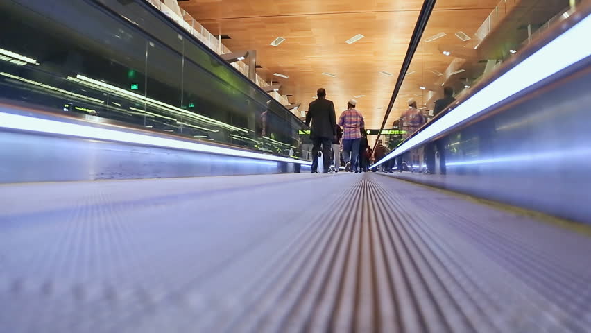 Moving sidewalk at an airport with people 1