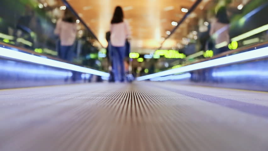 Moving sidewalk at an airport with people 3