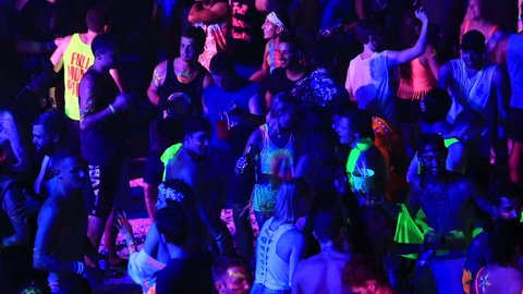 KOH PHANGAN,THAILAND - NOVEMBER 16, 2016 : Unidentified girls and boys dancing the Full Moon party in island Koh Phangan. The event now attracts anywhere from 40,000 party-goers on a normal month