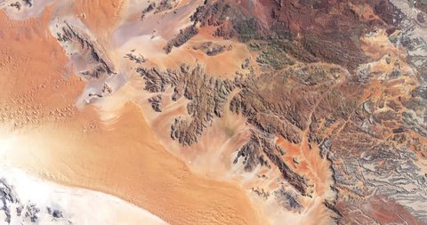 High-altitude overflight aerial of rocky terrain in the Namib desert.. Clip loops and is reversible. Elements of this image furnished by NASA 