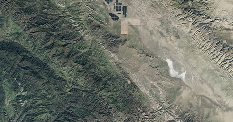High-altitude overflight aerial of the Topaz Solar Farm. Clip loops and is reversible. Elements of this image furnished by NASA 