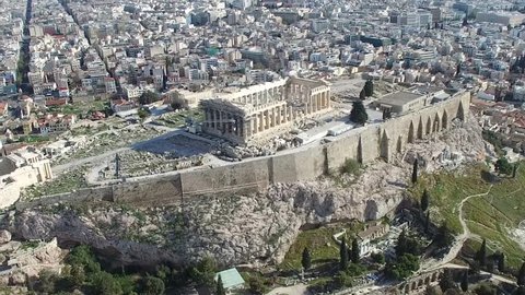Aerial drone bird view close up flight around the Acropolis of Athens ancient citadel located on rocky outcrop showing Parthenon very famous tourist attraction in Europe Greece nice European city 4k