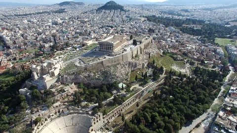 Aerial drone bird-eye view moving around back of the Acropolis of Athens ancient citadel located on rocky outcrop showing Parthenon very famous tourist attraction in Europe Greece European visit 4k