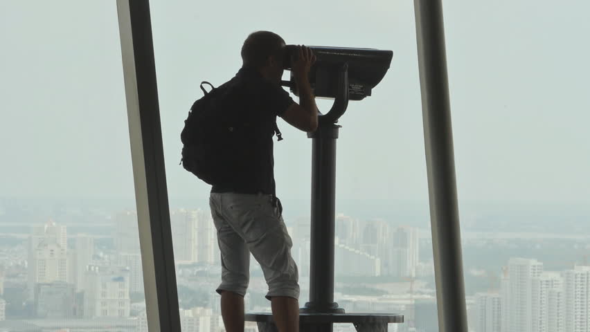 Turis looking through binoculars on observation deck in tower Ho Chi Minh city 3