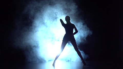 Latin dance in the studio, silhouette. Slow motion