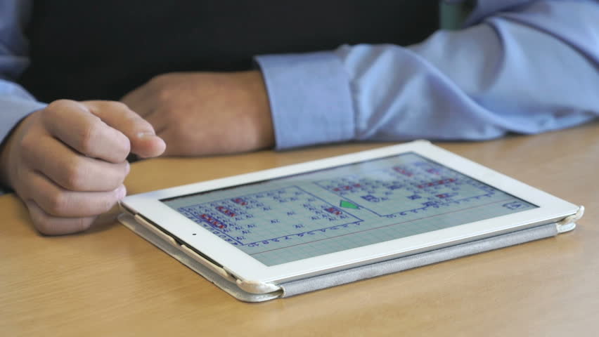 Schoolboy plays the game using the digital tablet