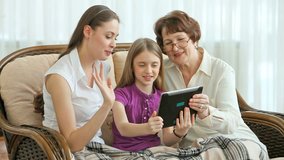 Women of three generations using modern technology to communicate