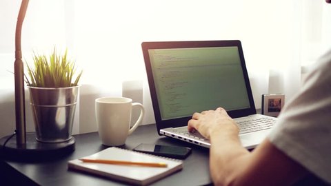 freelance website programmer working on laptop