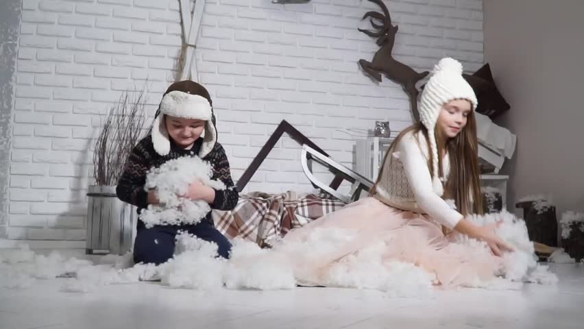 Small children sprinkled with artificial snow. Slow motion