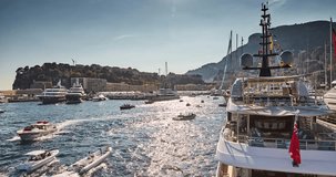 Timelapse of World Fair MYS Monaco Yacht Show, Port Hercules, luxury megayachts, big boat, sunny day, many shuttles, taxi boat, presentations, Journalists