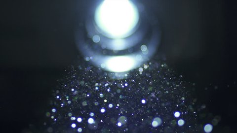 The bright projector illumination with dust particle stream. Macro close up view