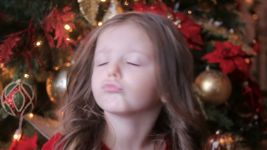 little girl three years in a red dress smiling and having fun