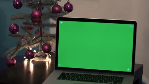 laptop greenscreen on a background christmas tree
