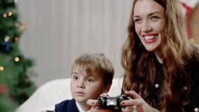 happy son and mother playing video game 