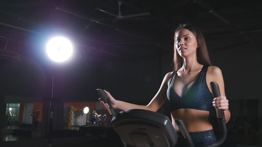 Young woman with elliptic machine