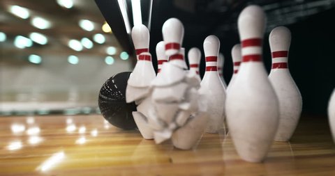 Bowling ball hits the pins and explodes them in super slow motion