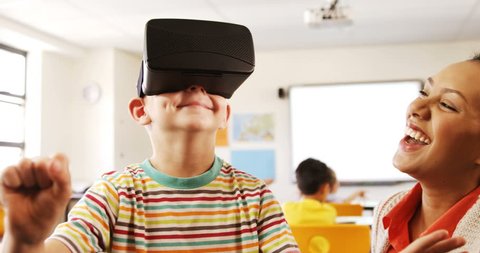 Side view of Caucasian boy using virtual reality headset in classroom at school วิดีโอสต็อก