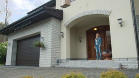 Smiling Woman Stands on a Porch While Flying Drone Delivers Her Postal Package to Her. Contactless Delivery Concept People Receiving Medical Aid, Essentials and Food Delivery in the Safety of Home - Powered by Shutterstock - Get 15% off with code: PIKWIZARD15