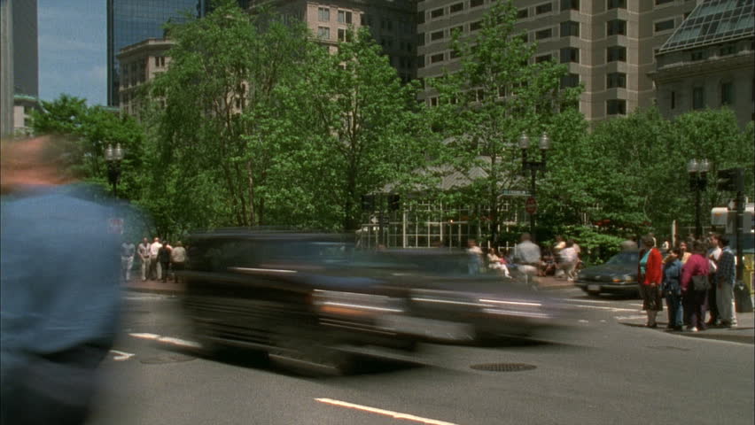 BROOKLINE, MA - CIRCA MAY 2001: Pedestrians cross a busy street corner in