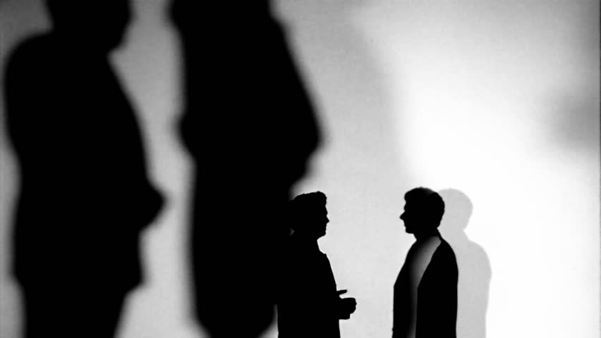 Silhouette of men talking