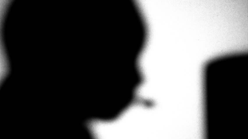 Silhouette of person talking on headset