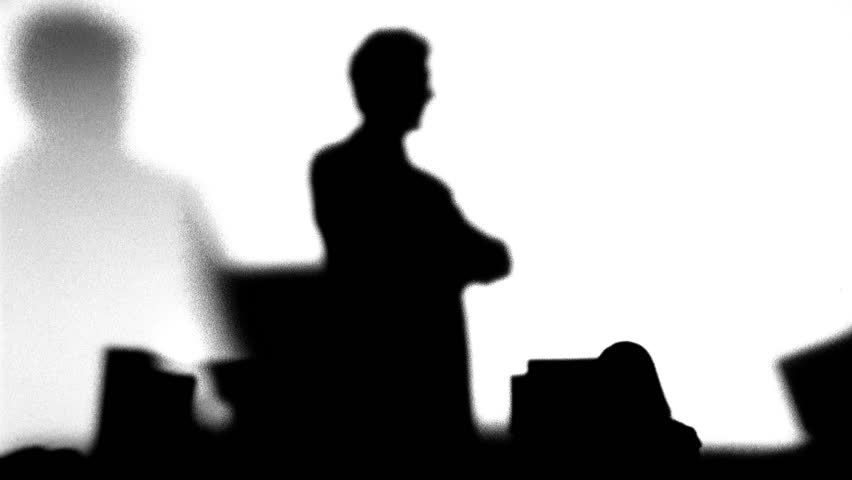 Silhouette of boss watching workers