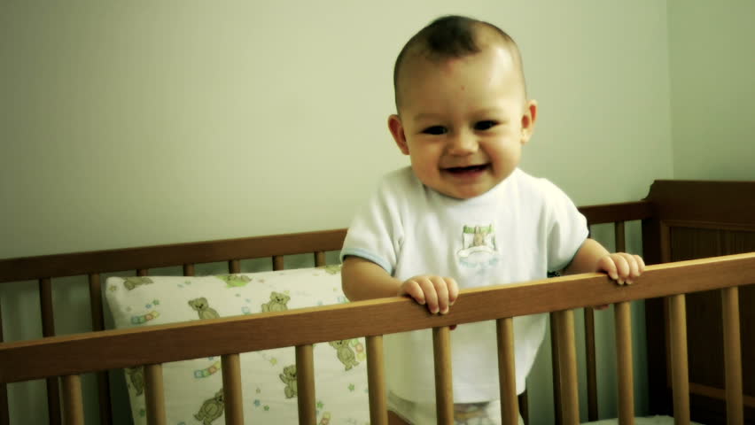 Big Smiles! Baby in cot smiling