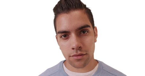 Wide angle close up portrait of Hispanic millennial with copyspace on white background. Latino man with solid backdrop looking at camera. 4k