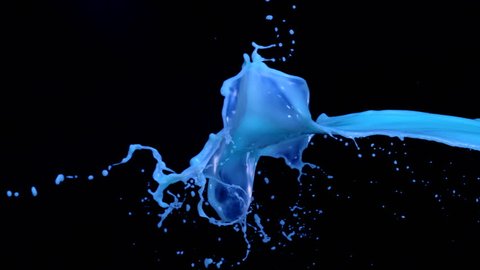 Milky blue liquid splash in the air on black background shooting with high speed camera, phantom flex.