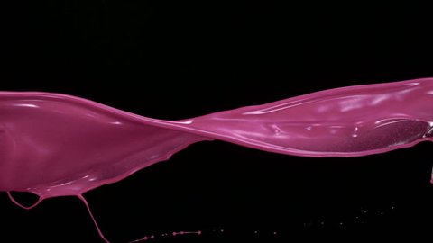 Pink liquid splash in the air on black background shooting with high speed camera, phantom flex.