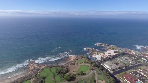 Aerial Panning view of Pelican Hill, Cameo Shores, Shorecliffs, looking toward Newport Beach Harbor entrance, with Balboa Island, Newport Peninsula, and in the distance.