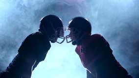Two guys football player facing their helmets in the smoke. Slow motion - Powered by Shutterstock - Get 15% off with code: PIKWIZARD15