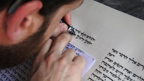 AUCKLAND - NOV 20 2016:Sofer writes a sefer Torah in Hebrew. In the Torah's 613 commandments, the second to last is that every Jew should write a Sefer Torah in their lifetime.