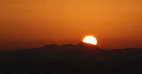 Time lapse of beautiful sunrise behind mountain: 4K footage 