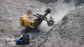 Four 4 video Career excavator dredge ship loads stone in truck, drove up to slope,dredge pours stone, pulls, turns on its axis, loaded truck leaves. Top view close-up Timelapse fast video - Powered by Shutterstock - Get 15% off with code: PIKWIZARD15